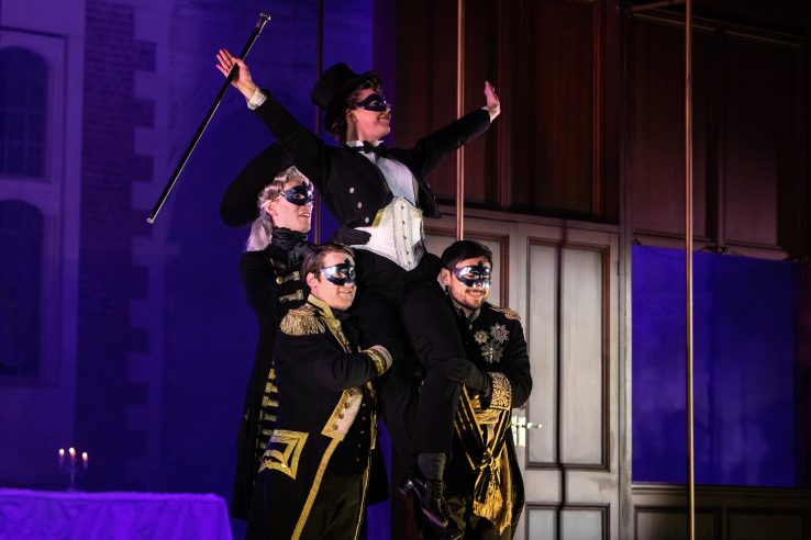 Alison Langer as Oscar with members of the Opera Holland Park Chorus in Un ballo in maschera at Opera Holland Park © Ali Wright